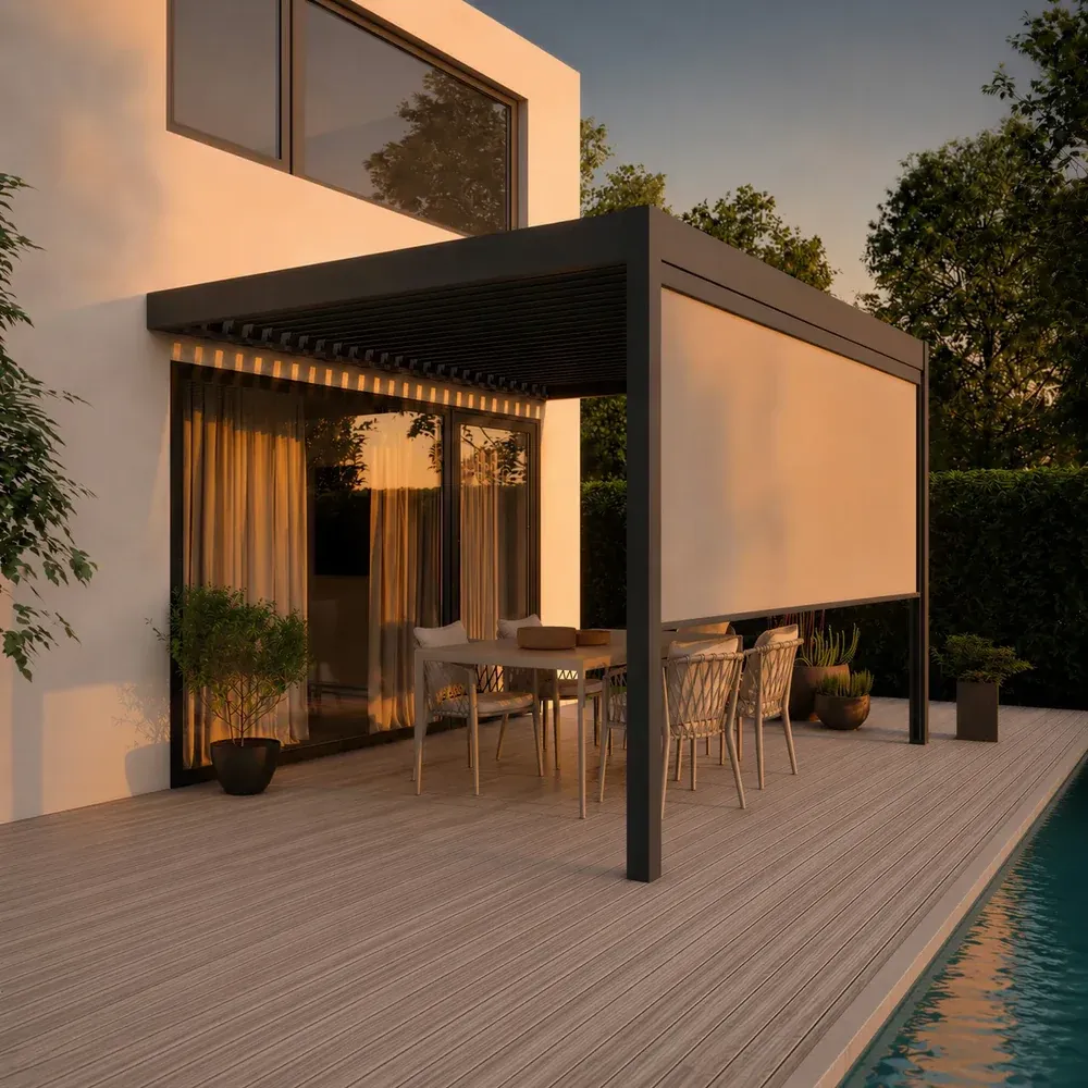 Pergola bioclimatique en aluminium anthracite adossée à une maison, lames orientables, store vertical descendu et éclairage intégré, au-dessus d’une terrasse en bois en bord de piscine